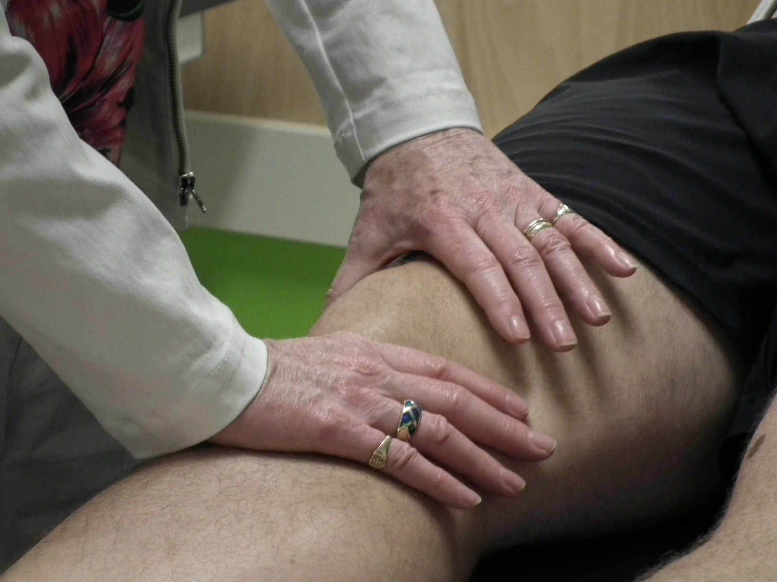 A person is getting their leg examined by an osteopath.